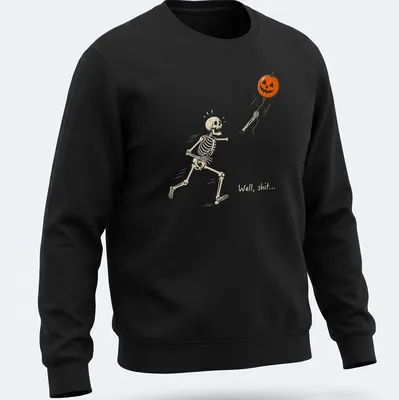 Cartoon skeleton chasing a pumpkin balloon with humorous text above — printed on a unisex sweatshirt