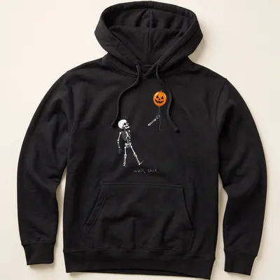 Cartoon skeleton holding a pumpkin balloon with humorous text — printed on a unisex hoodie