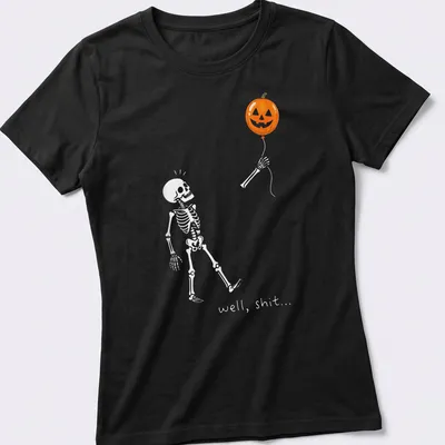 Cartoon skeleton holding a pumpkin balloon with humorous text — printed on a women's shirt