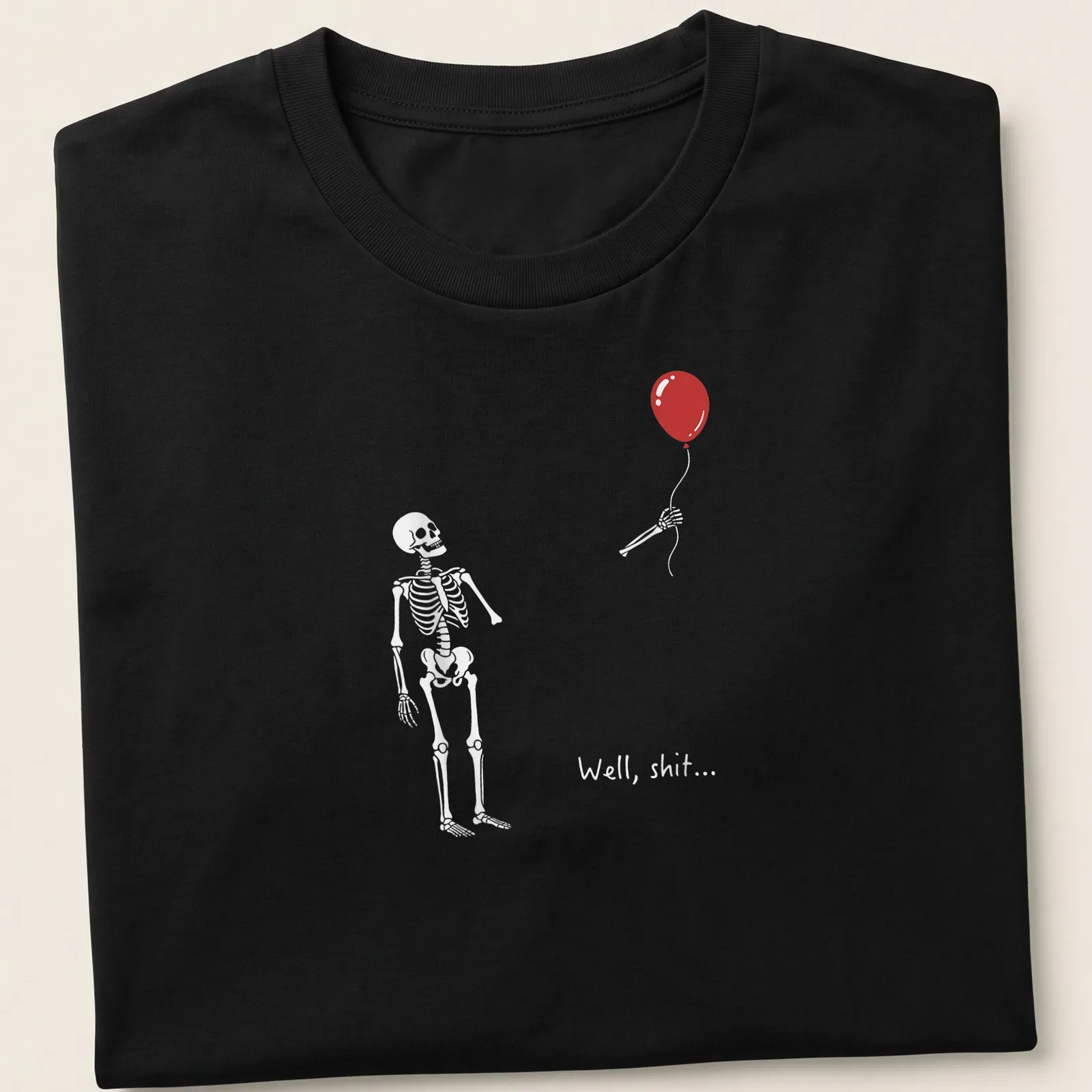 Skeleton with red balloon and the text 'Well, shit...' in a humorous design — printed on a unisex t-shirt