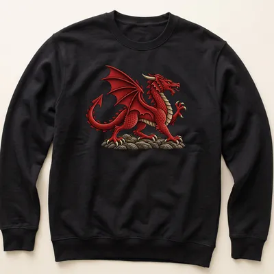 Illustration of a Welsh Red Dragon on a cream background with detailed features in red, black, and grey — printed on a unisex sweatshirt