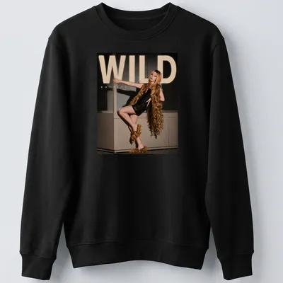 Bold WILD Katseye text above an illustration of a fashion model in gold and black — printed on a unisex sweatshirt