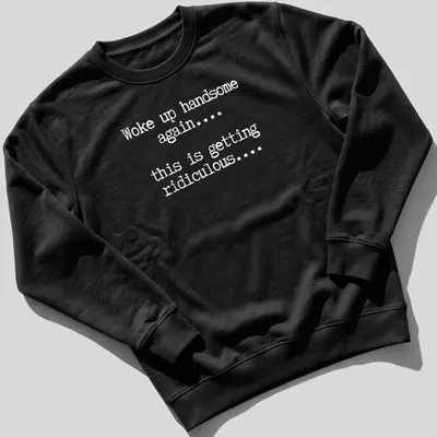 Humorous text tee reading 'Woke up handsome again... this is getting ridiculous...' — printed on a unisex sweatshirt